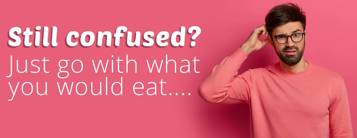 Confused man scratching his head wearing pink sweater on pink background with text still confused just go with what you would eat